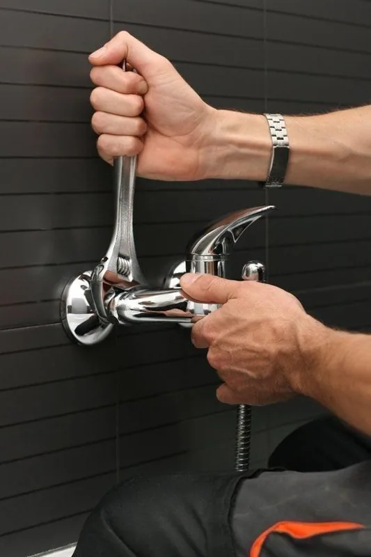 Réparation de robinetterie avec une clé — service de plombier à Saint-Gilles